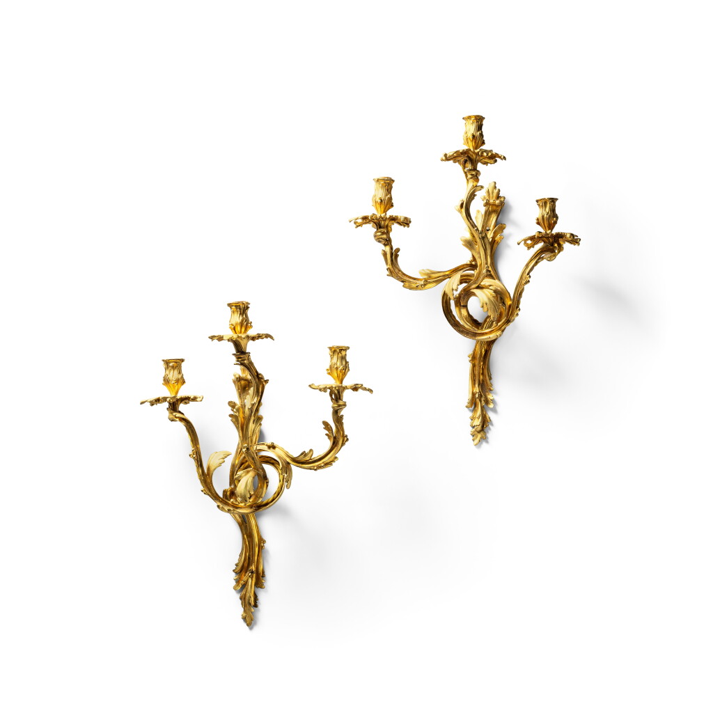 View full screen - View 1 of Lot 330. A pair of Louis XV style gilt-bronze three-light wall-lights, 19th century.