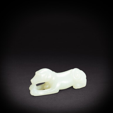 View full screen - View 1 of Lot 6885. A white jade recumbent dog, Qing dynasty, 19th century | 清十九世紀 白玉臥犬.