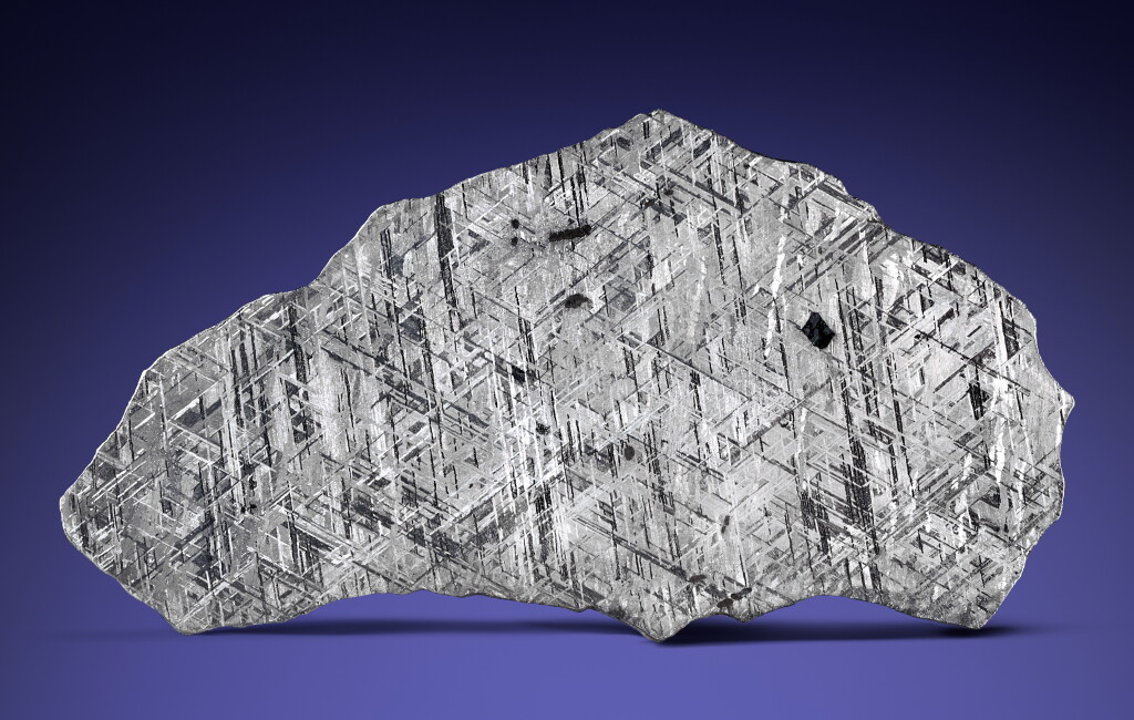 View full screen - View 1 of Lot 109. Gibeon Meteorite — Complete Slice With Chromite Crystal.