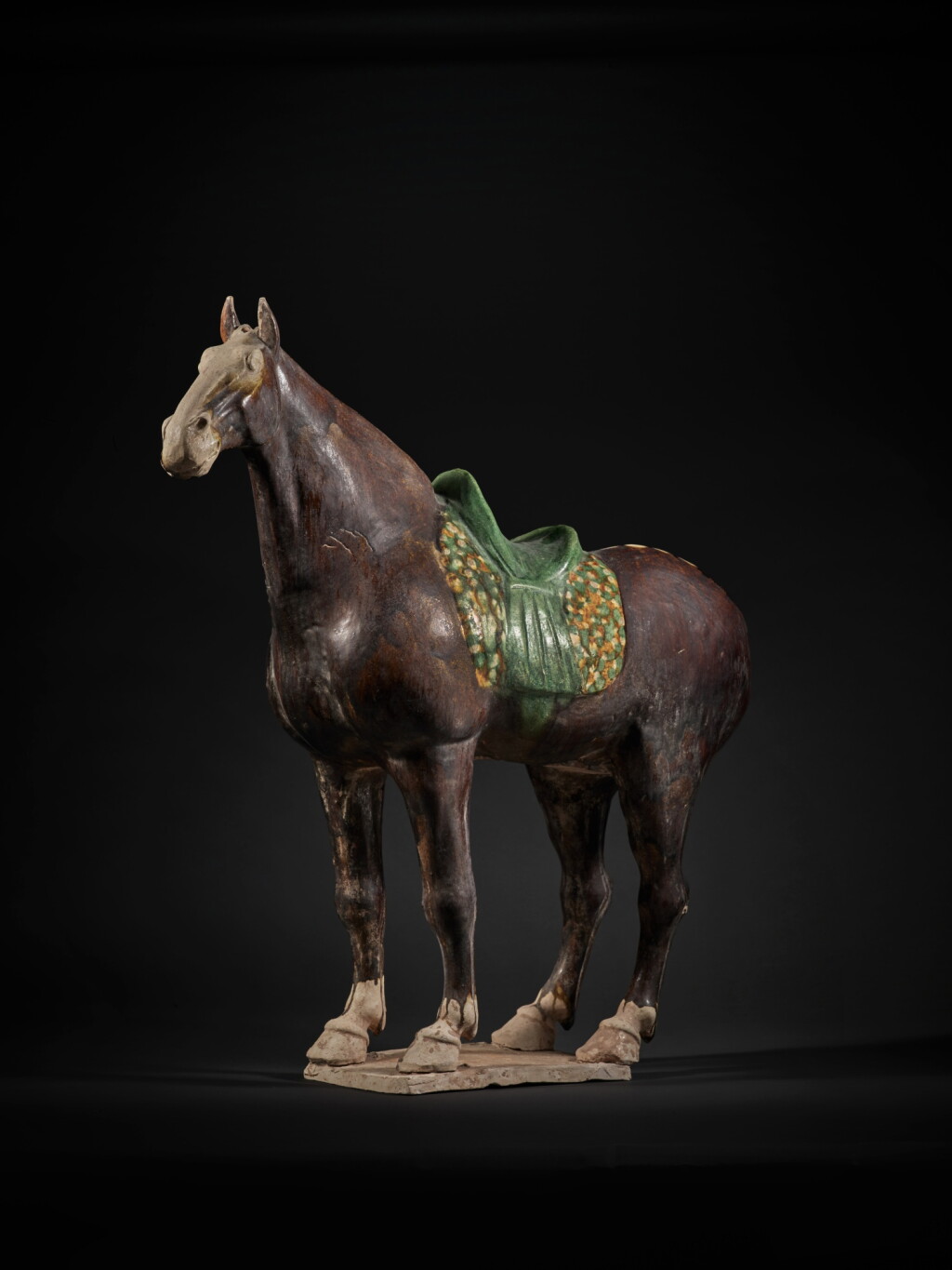 View full screen - View 1 of Lot 207. A rare brown and sancai-glazed pottery figure of a horse, Tang dynasty.
