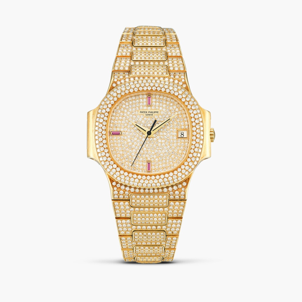 View full screen - View 1 of Lot 2313. Nautilus, Reference 3800 | A yellow gold, diamond and ruby-set bracelet watch with date, Circa 1995.