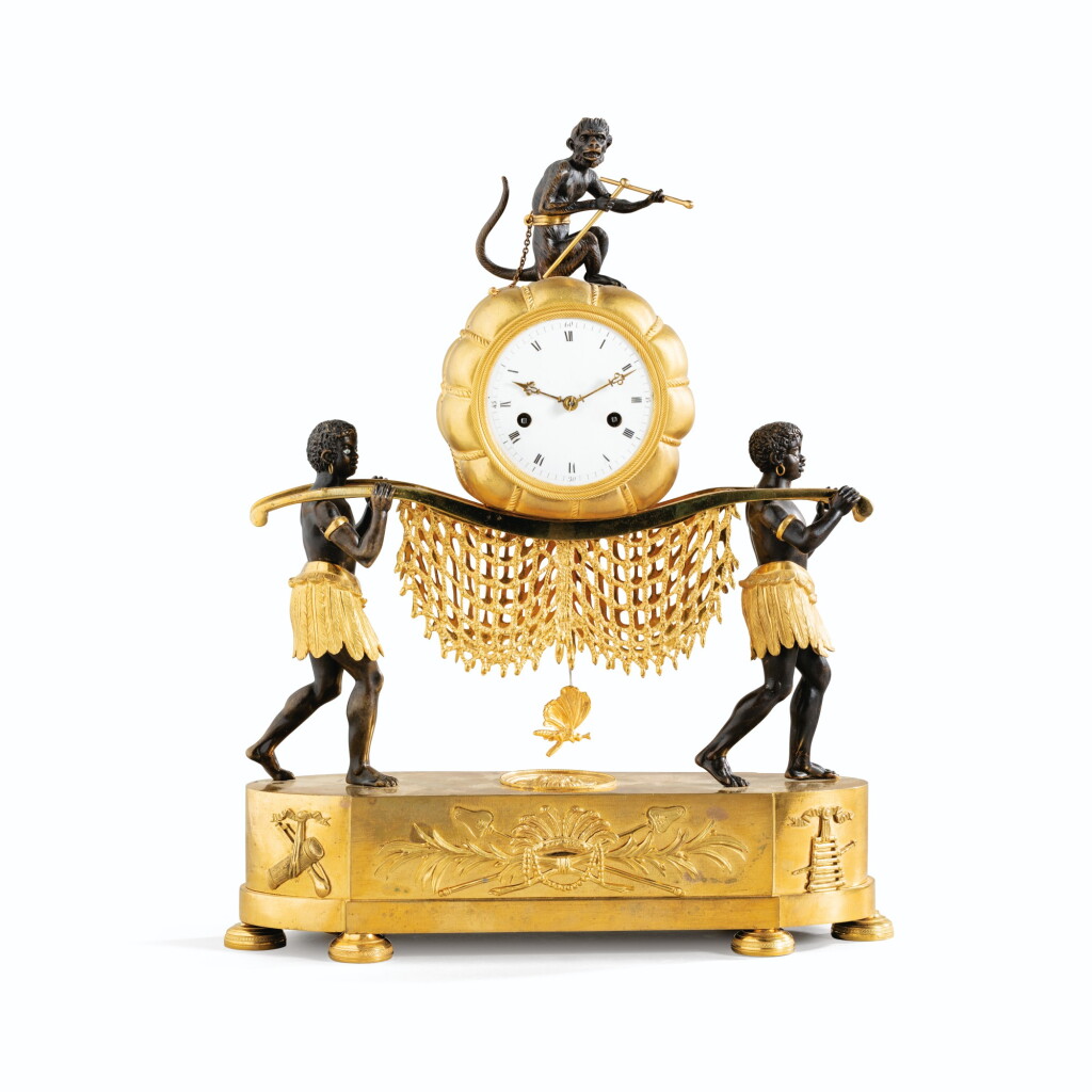 View full screen - View 1 of Lot 94. A RESTAURATION PATINATED GILT-BRONZE PENDULE | PENDULE AUX SAUVAGES EN BRONZE PATINÉ ET DORÉ D'ÉPOQUE RESTAURATION.