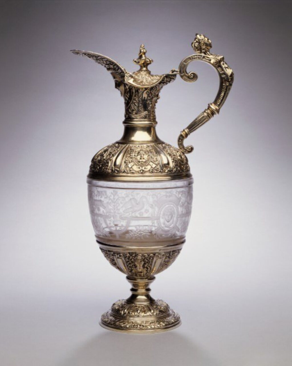 View full screen - View 1 of Lot 329. A Victorian Silver-Mounted Etched Glass "Cellini pattern" Claret Jug, George Fox, London, 1891.