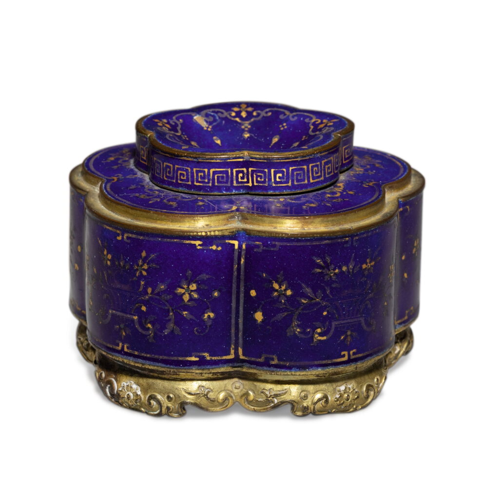 View full screen - View 1 of Lot 348. A gilt-decorated blue-ground enamel lobed inkwell and cover, Seal mark and period of Qianlong | 清乾隆 銅胎畫琺瑯藍地描金花卉紋墨水瓶 《乾隆年製》款.