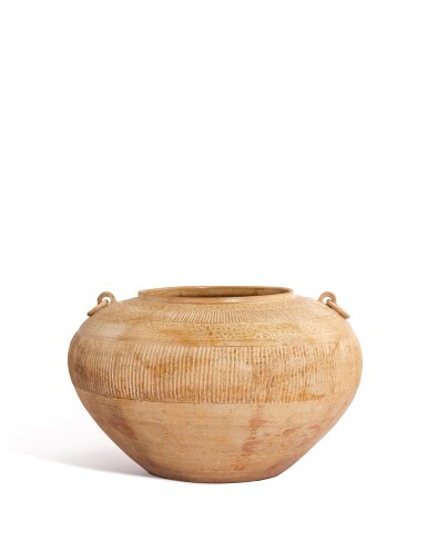 View full screen - View 1 of Lot 5147. An ash-glazed proto-porcelain handled jar, Eastern Zhou dynasty, Warring States period | 東周戰國 原始青瓷豎條紋雙繫罐.