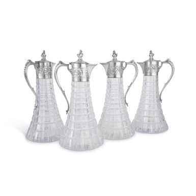 View full screen - View 1 of Lot 135. A Set of Four English Silver-Mounted Cut-Glass Claret Jugs, Collingwood & Co., London, 1977.