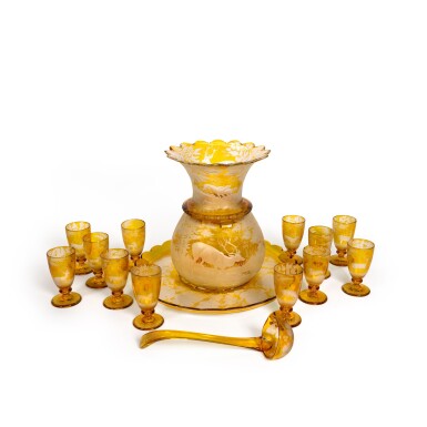 View full screen - View 1 of Lot 105. A Bohemian amber-stained and engraved glass punch set, late 19th century.