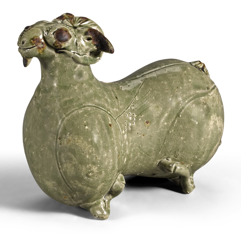 View full screen - View 1 of Lot 127. A RARE 'YUE' FIGURE OF A RECUMBENT RAM WESTERN JIN DYNASTY, 3RD CENTURY AD | 西晉 三世紀 越窰青釉臥羊水注.