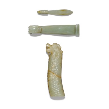 View full screen - View 1 of Lot 31. A celadon and russet jade 'dragon' handle and two celadon jade belt hooks Qing dynasty, 19th century | 清十九世紀 褐斑青玉刀柄 及 青玉帶鉤兩件.