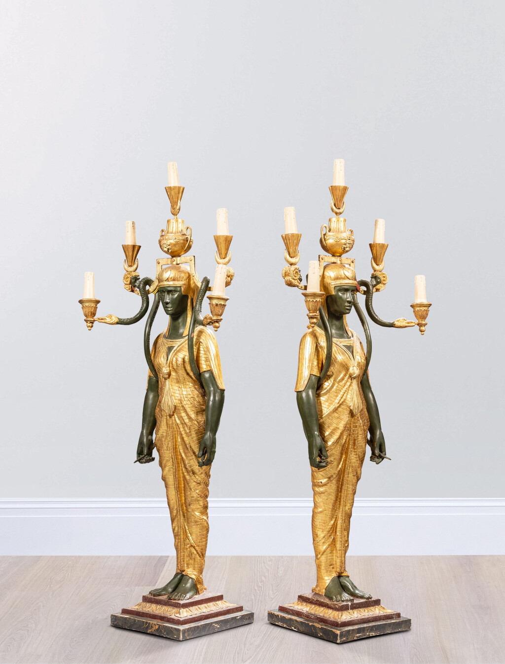 View full screen - View 1 of Lot 135. A pair of monumental patinated and gilt-wood torchères, first half of 20th century, after a model by Martin-Eloi Lignereux.