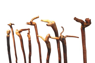 View full screen - View 1 of Lot 112. TWELVE EXCEPTIONAL FIGURATIVELY CARVED WOODEN WALKING STICKS, 20TH CENTURY.