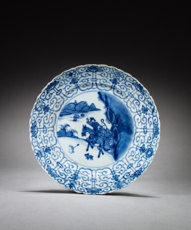 View full screen - View 1 of Lot 66. A blue and white 'hunting scene' barbed-rim dish, Qing dynasty, Kangxi period | 清康熙 青花狩獵圖菱口盤《大明成化年製》仿款.