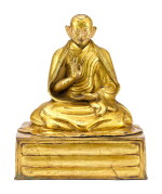 A GILT-BRONZE FIGURE OF A LAMA, POSSIBLY THE FIRST PANCHEN LAMA, TIBET, 18TH CENTURY | 十八世紀 藏傳鎏金銅喇嘛坐像,或為班禪喇嘛一世