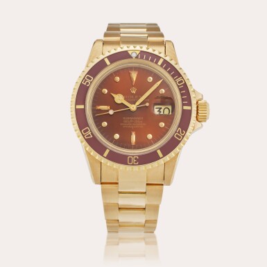 View full screen - View 1 of Lot 136. Reference 1680 Submariner | A yellow gold automatic wristwatch with date, bracelet, and tropical nipple dial, Circa 1975.