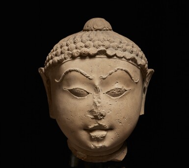 View full screen - View 1 of Lot 371. A polished sandstone head of a Jina, Western India, 12th/13th Century.