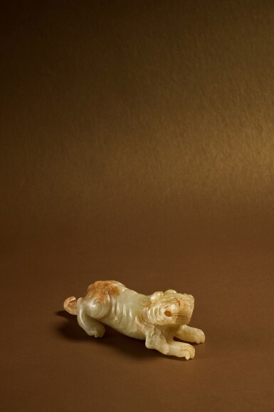 View full screen - View 1 of Lot 117. A pale green jade carving of a mythical beast (Bixie), Six dynasties.