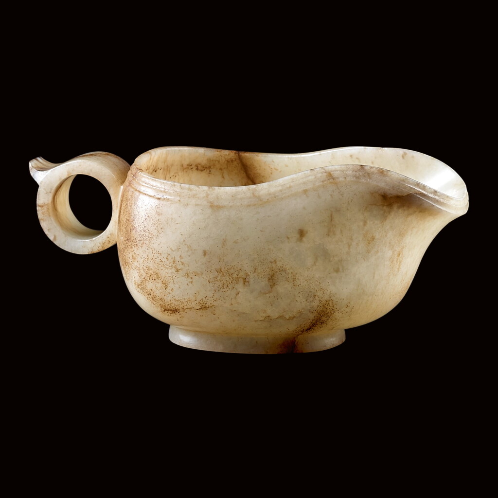 View full screen - View 1 of Lot 55. AN ARCHAISTIC JADE HANDLED CUP, YI MING DYNASTY | 明 仿古玉匜.