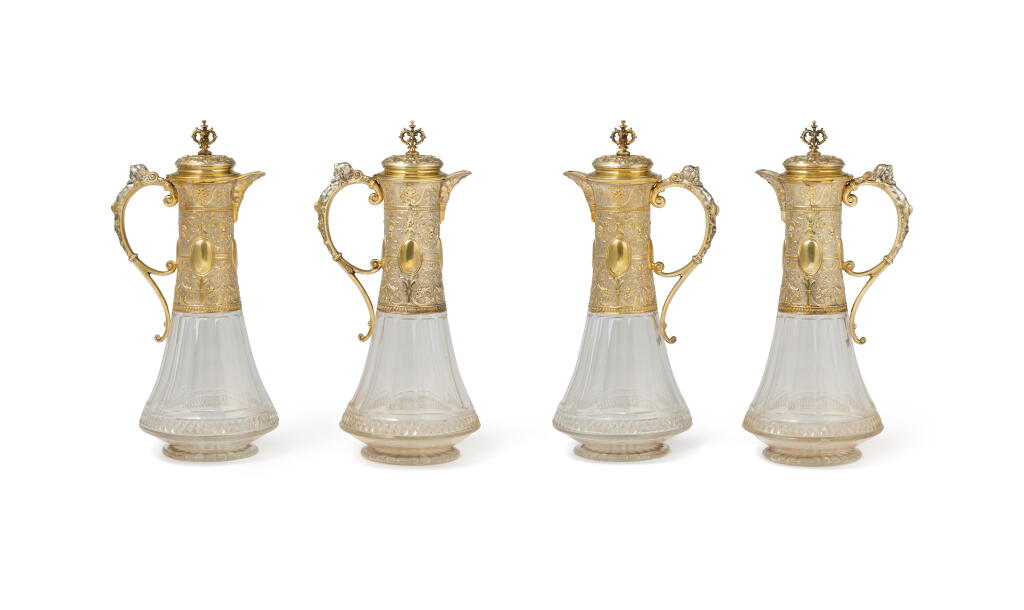 View full screen - View 1 of Lot 21. A set of four German parcel-gilt silver-mounted glass claret jugs | Gruppe von vier Rotweinkrügen aus Glas, vergoldetem Silver und mit Silberfassungen.