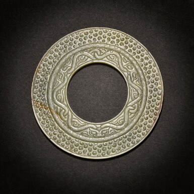 View full screen - View 1 of Lot 5. A green jade disc (Bi), Eastern Zhou dynasty, Warring States period.
