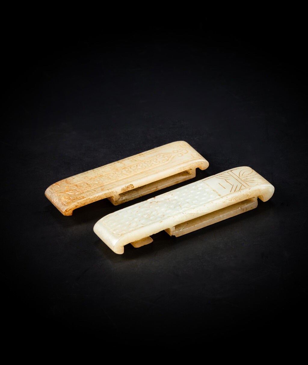View full screen - View 1 of Lot 123. Two celadon archaistic scabbard slides, Qing dynasty or earlier | 清或更早 清或更早 青白玉雕劍璏 一組兩件.