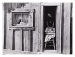 Wife and baby of president of Ola self-help sawmill co-op in doorway of their home, Gem County, Idaho