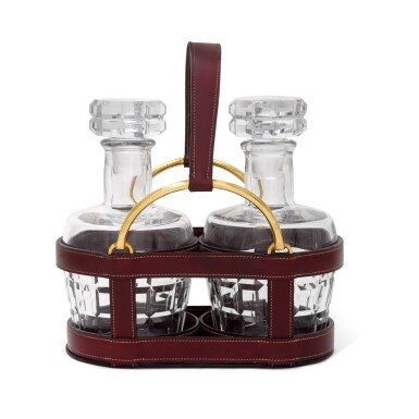 View full screen - View 1 of Lot 98. A leather double decanter holder, Hermès, Paris, circa 1960, designed by Jacques Adnet.
