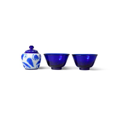 View full screen - View 1 of Lot 579. Three blue glass vessels, 19th / 20th century | 十九 / 二十世紀 藍料盌一對及涅白地套藍料雲福紋小蓋罐.