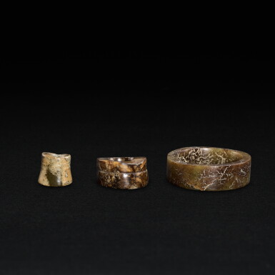 View full screen - View 1 of Lot 512. A celadon jade cylindrical pendant, a bangle, and an earring, Neolithic period, Liangzhu culture - Shang dynasty | 新石器時代良渚文化至商 玉環兩件及玉耳環一件.