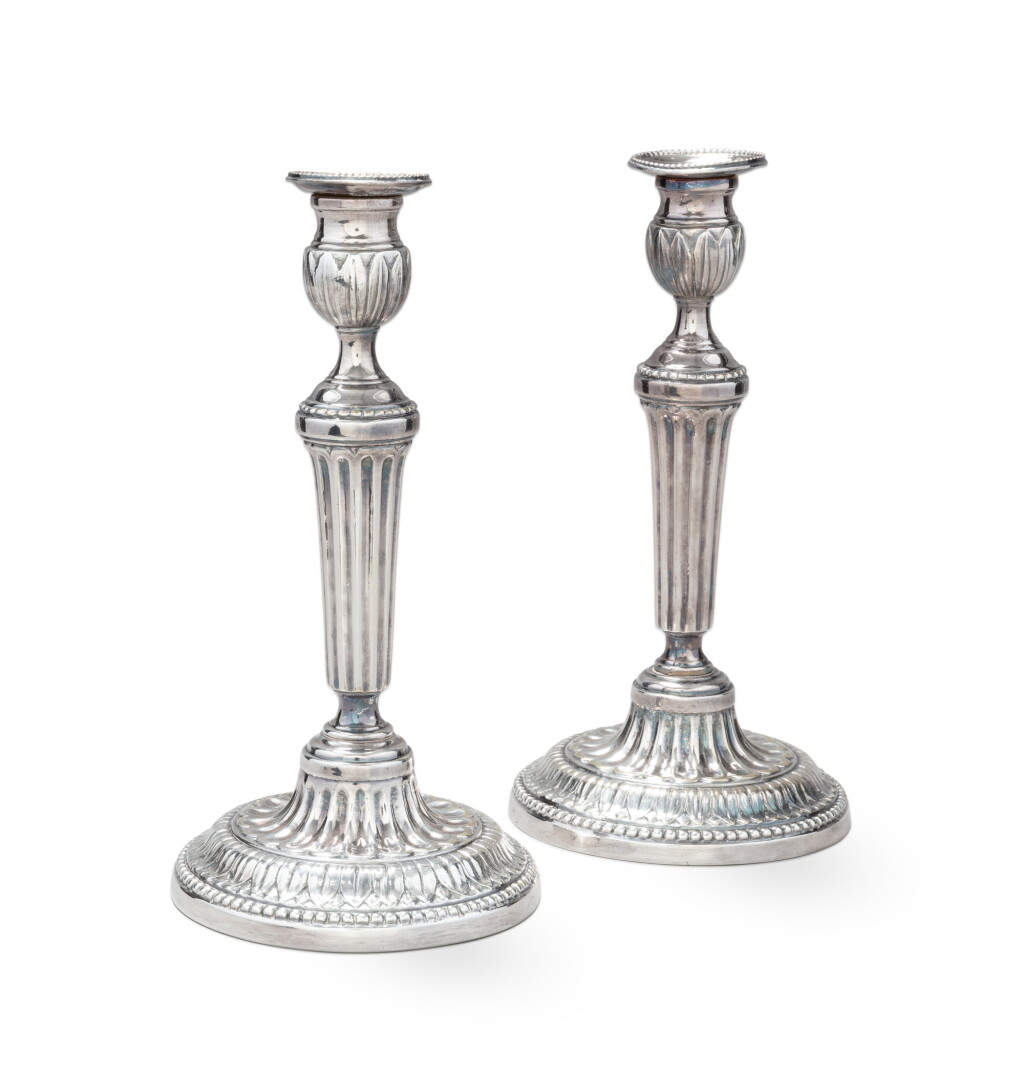 View full screen - View 1 of Lot 80. A pair of Louis XVI style silver-plated bronze candlesticks and nozzles, France, 19th century | Paire de flambeaux et leurs bobèches de style Louis XVI en bronze argenté, France, XIXe siècle.