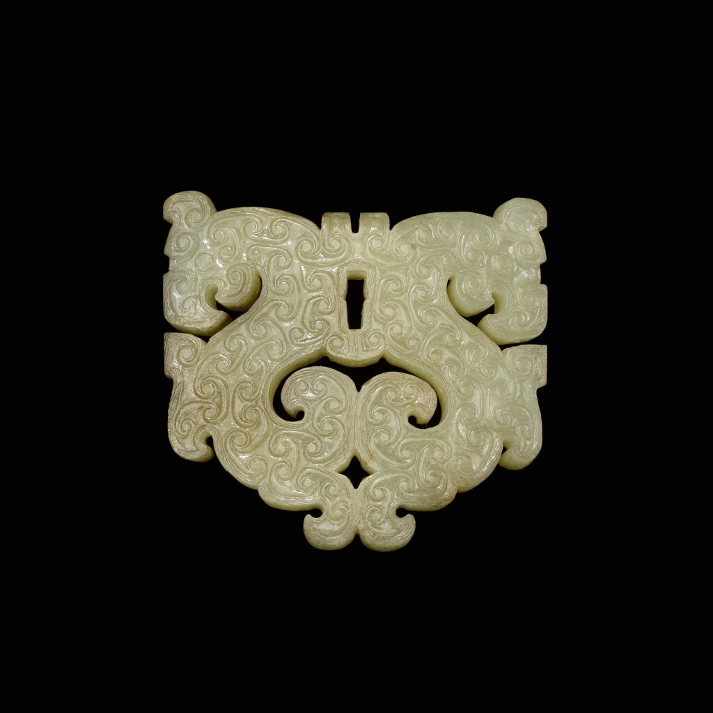 View full screen - View 1 of Lot 133. A reticulated celadon jade 'dragon' plaque, Eastern Zhou dynasty | 東周 青白玉透雕雙龍紋飾.
