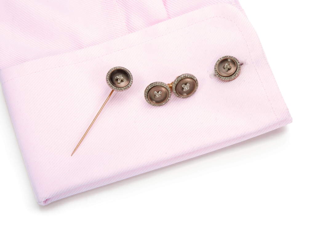 View full screen - View 1 of Lot 1064. MOTHER OF PEARL AND DIAMOND CUFFLINKS AND STICK PIN, EARLY 20TH CENTURY.