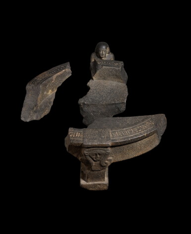View full screen - View 1 of Lot 32. An Egyptian Basalt Basin-bearing Figure of the Customs Chief Wahibre, Reign of Amasis, 570-526 B.C..