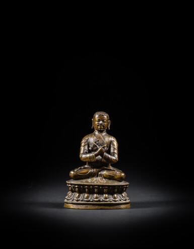 View full screen - View 1 of Lot 54. An inscribed copper-alloy seated figure of a Lama, Tibet, probably 16th century.