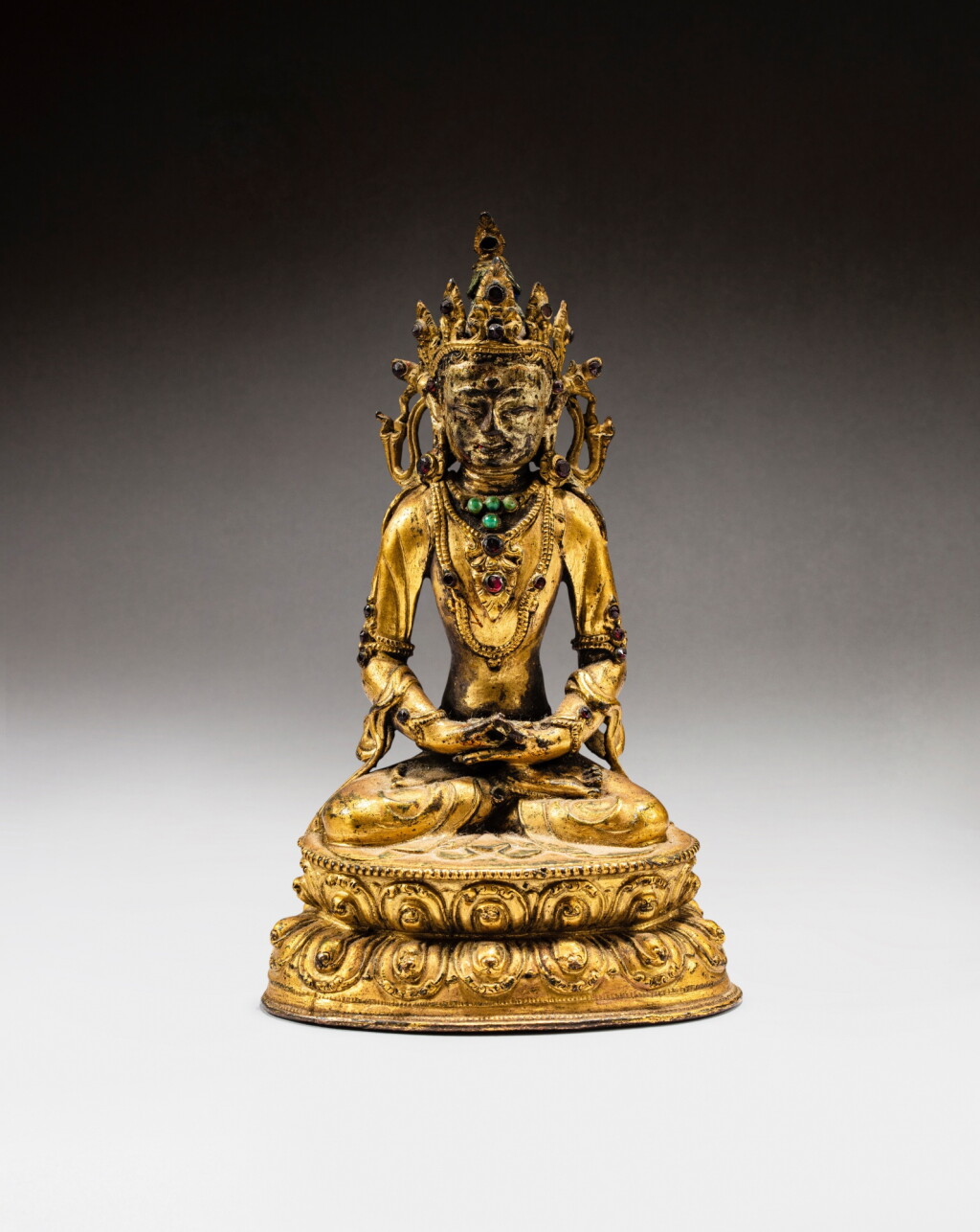 View full screen - View 1 of Lot 57. A gilt-bronze figure of Amitayus, Tibet, 15th - 16th century | 西藏 十五至十六世紀 鎏金銅無量壽佛坐像.