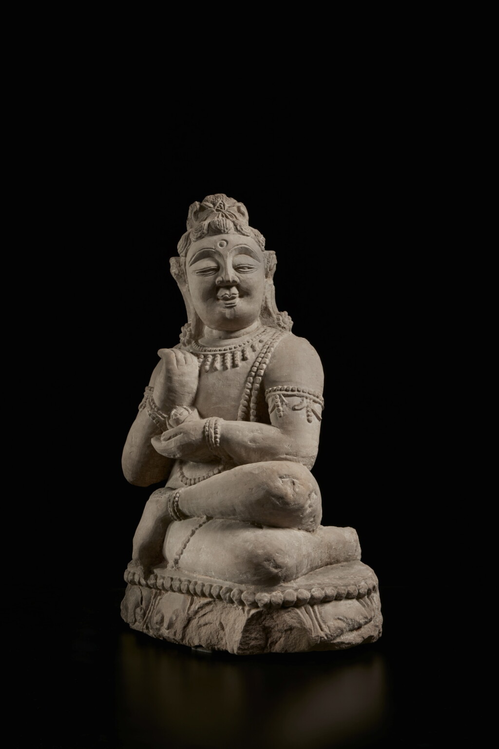View full screen - View 1 of Lot 372. A carved sandstone figure of a seated bodhisattva, Tibet / China, 13th / 14th century.