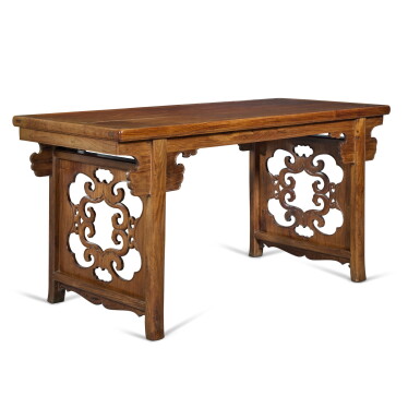 View full screen - View 1 of Lot 375. A large ‘huanghuali’ and 'huali' recessed-leg table (Pingtouan), Qing dynasty | 清 黃花梨拼花梨木夾頭榫靈芝牙頭透雕擋板平頭案.