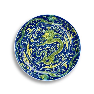 View full screen - View 1 of Lot 3696. A blue-ground yellow-enamelled 'dragon' dish, Mark and period of Kangxi | 清康熙 藍地黃彩雲龍紋盤 《大清康熙年製》款.