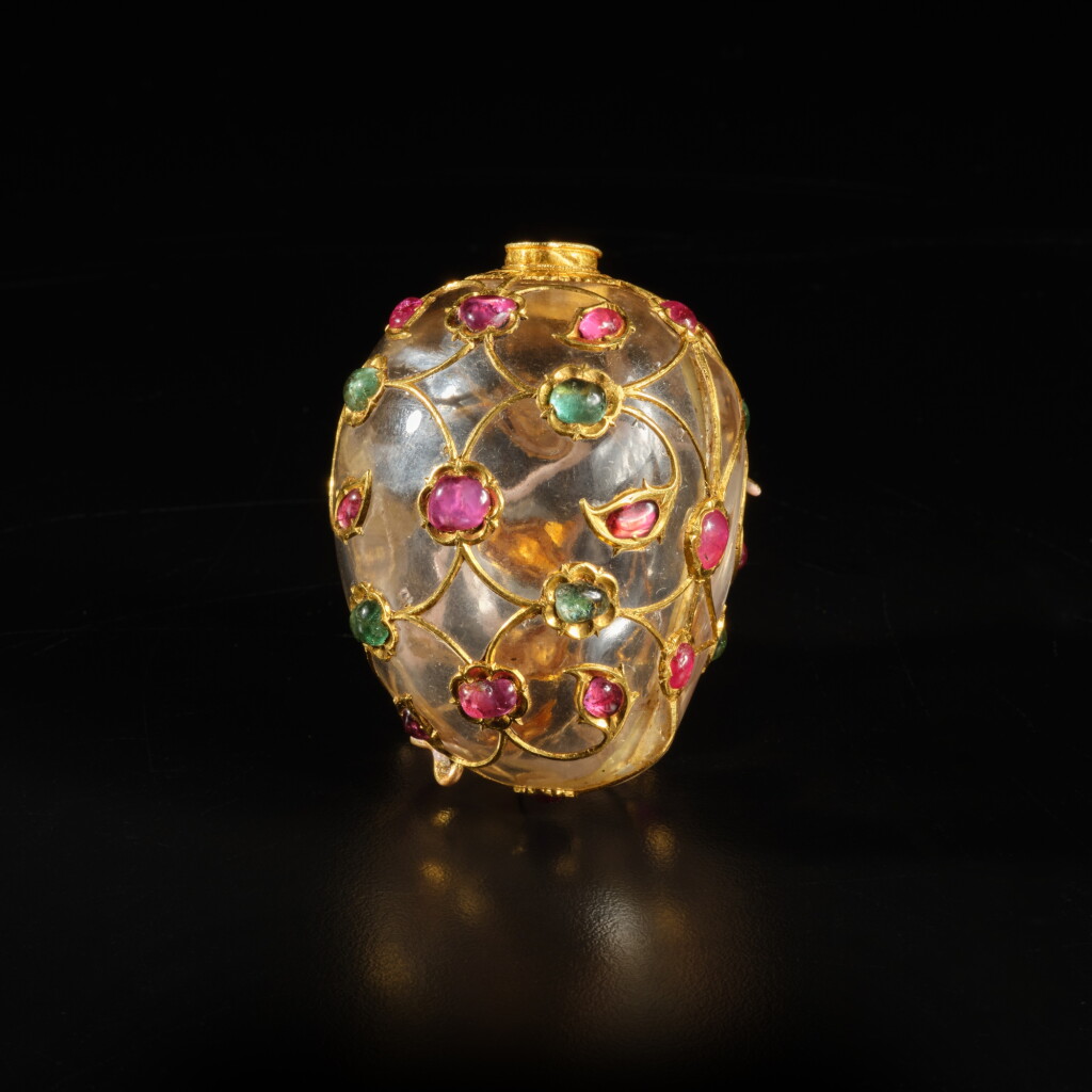 View full screen - View 1 of Lot 21. A Mughal rock crystal mango-shaped flask inlaid with rubies and emeralds set in gold, India, Mughal, mid-17th century.