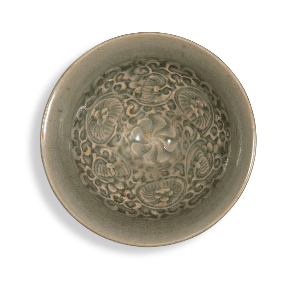 View full screen - View 1 of Lot 249. A molded 'Yaozhou' 'floral' bowl, Northern Song / Jin dynasty | 北宋 / 金 耀州窰青釉印纏枝花卉紋盌.