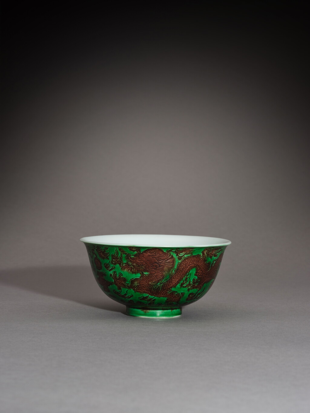 View full screen - View 1 of Lot 86. A green-ground aubergine-enamelled 'dragon' bowl, Mark and period of Kangxi | 清康熙 綠地紫彩龍紋盌 《大清康熙年製》款.