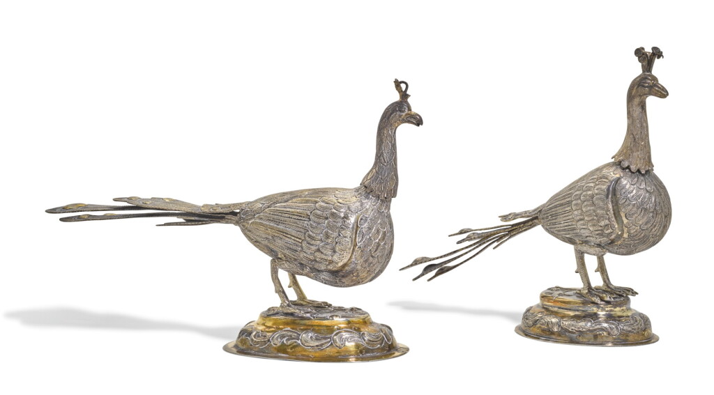 View full screen - View 1 of Lot 101. TWO SIMILAR AUSTRO-HUNGARIAN PARCEL-GILT SILVER MODELS OF PEACOCKS, 18TH CENTURY.