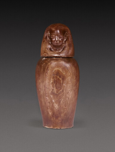View full screen - View 1 of Lot 141. An Egyptian Banded Alabaster Canopic Jar, 26th Dynasty, 664-525 B.C..