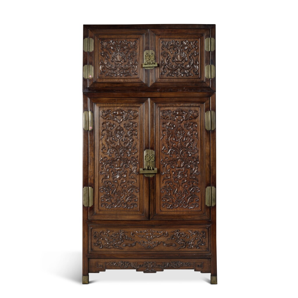 View full screen - View 1 of Lot 1351. A large 'hongmu' foliate-carved compound cabinet (Dingxianggui), Late Qing dynasty | 清末 紅木雕花頂箱櫃.