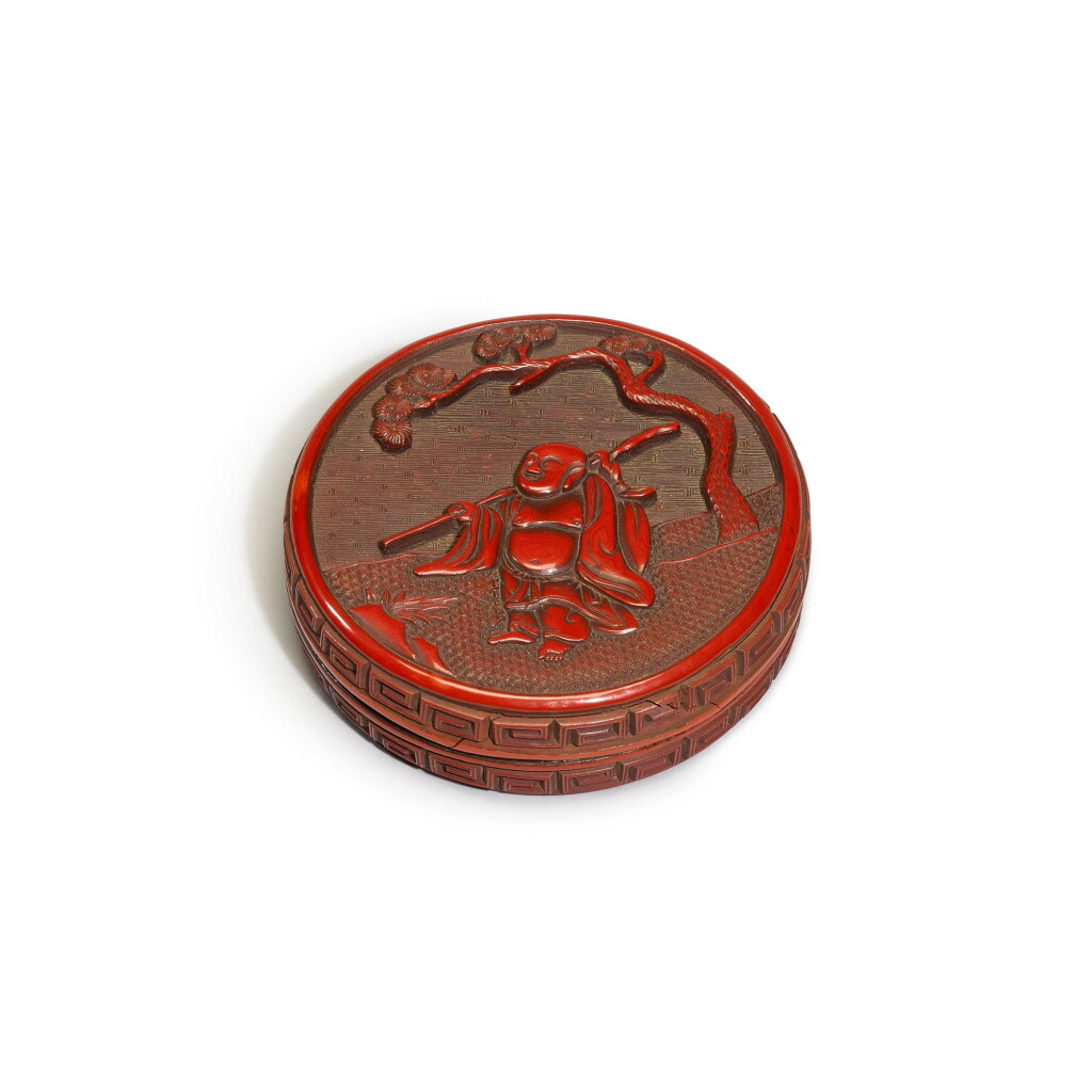 View full screen - View 1 of Lot 201. A small carved cinnabar lacquer ‘Budai’ box and cover, Ming dynasty, 16th / 17th century | 明十六 / 十七世紀 剔紅布袋和尚香盒.