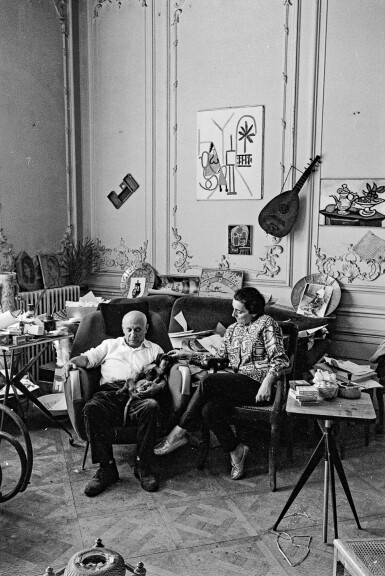 View full screen - View 1 of Lot 102. EDWARD QUINN | 'PABLO PICASSO AND JACQUELINE (SHE IS WEARING A BLOUSE MADE FROM A TEXTILE DESIGNED BY PABLO PICASSO) WITH DACHSHUND MA JOLIE. LA CALIFORNIE, CANNES', 1961.