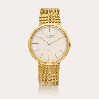 View full screen - View 1 of Lot 396. Reference 2591 Calatrava | Retailed by Gübelin: A yellow gold wristwatch with bracelet, Circa 1961.