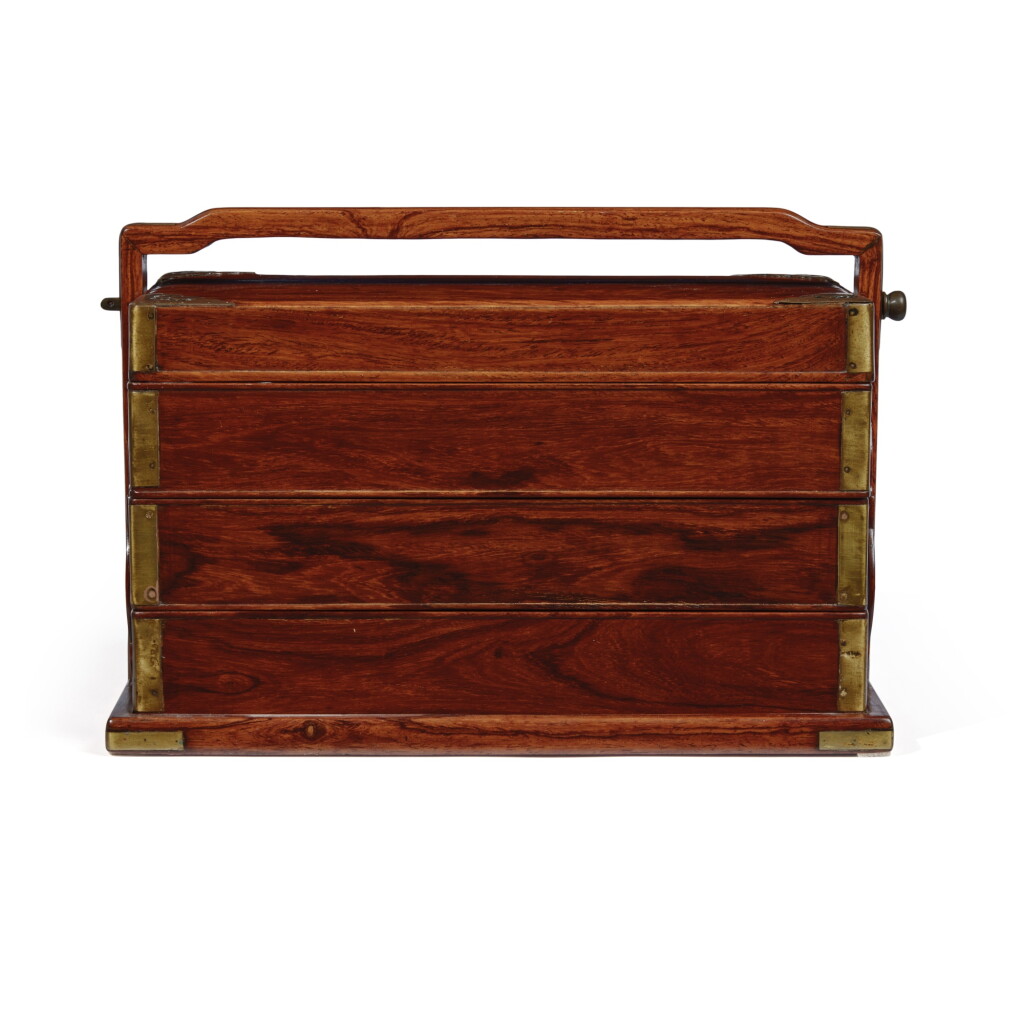 View full screen - View 1 of Lot 1130. A 'huanghuali' and 'hardwood' three-tier picnic box and cover, 19th / 20th century | 十九 / 二十世紀 黃花梨拼硬木三層提盒.