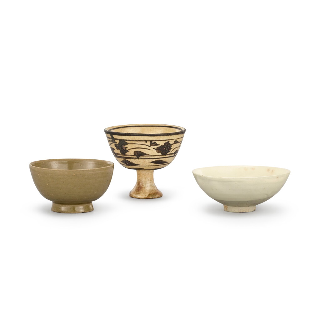 View full screen - View 1 of Lot 406. A YUE CELADON CUP, A CIZHOU PAINTED STEMCUP AND A CIZHOU WHITE-GLAZED CARVED BOWL SONG DYNASTY | 宋 越窰青釉盞、磁州黑彩花卉紋高足盃及磁州白釉盌一組三件.