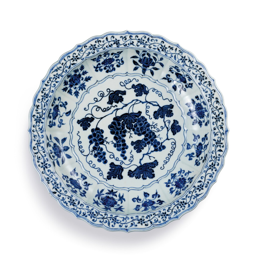 View full screen - View 1 of Lot 3612. An exceptional and rare blue and white barbed 'grape' charger Ming Dynasty, Yongle Period | 明永樂 青花葡萄紋折沿菱口盤.