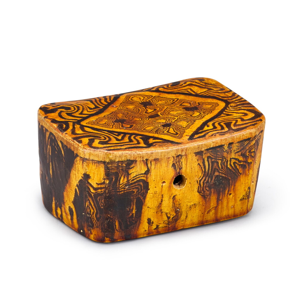 View full screen - View 1 of Lot 426. An amber-glazed marbled pillow Tang dynasty | 唐 黃釉絞胎枕.